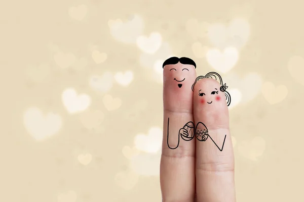 Conceptual Easter Finger Art. La pareja sostiene huevos pintados. Imagen de stock — Foto de Stock