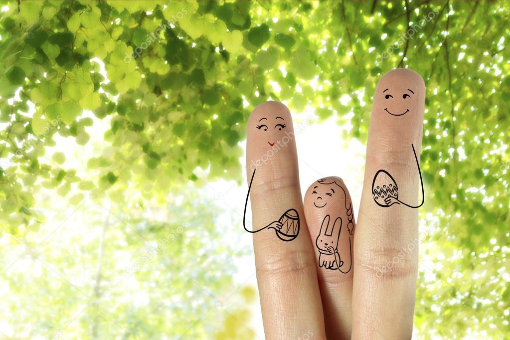 Conceptual Easter Finger Art. Family Are Holding Painted Eggs. daughter is holding Easter bunny. Stock Image