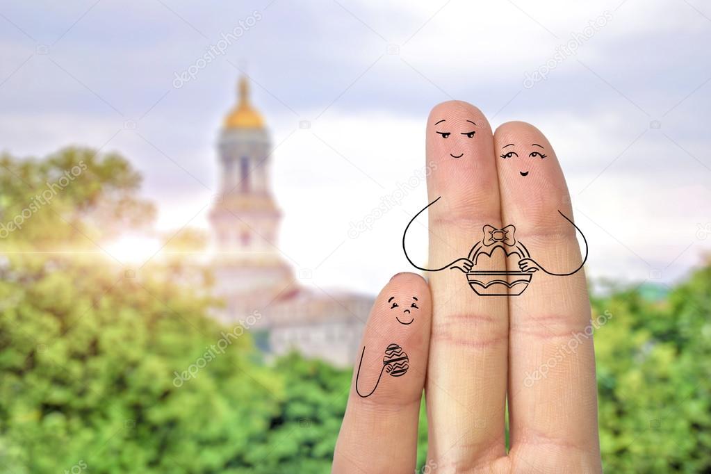 Conceptual easter finger art. Family are holding basket with Painted eggs. Child is holding painted easter egg