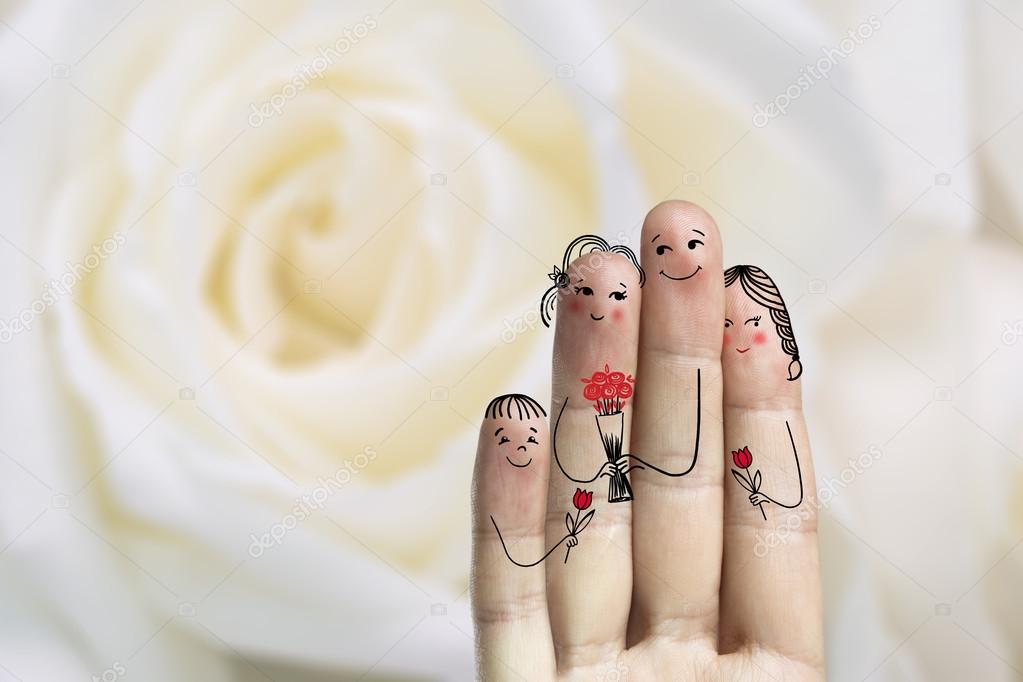Conceptual family finger art. Father, son and daughter are giving flowers their mother. Stock Image