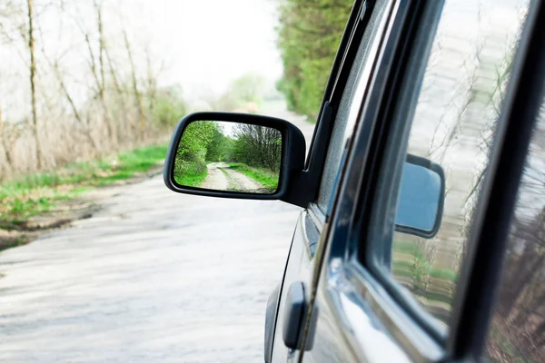 Landscape in the side view mirror of a speeding car — Stock Photo, Image