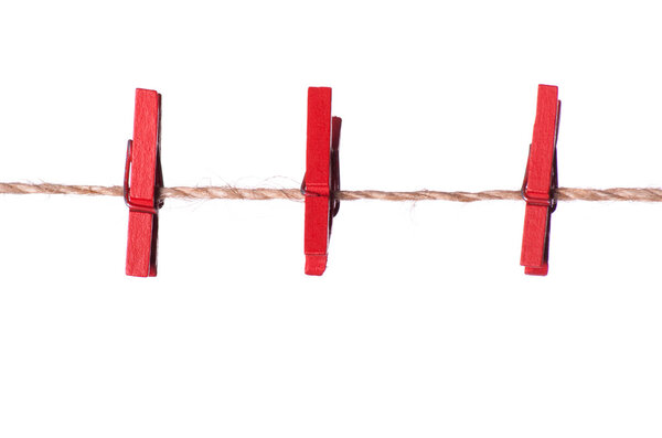 Red clothespins on a rope
