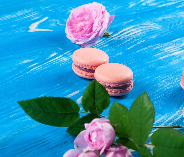 Multicolored macaroon on blue boards. — Stock Photo, Image