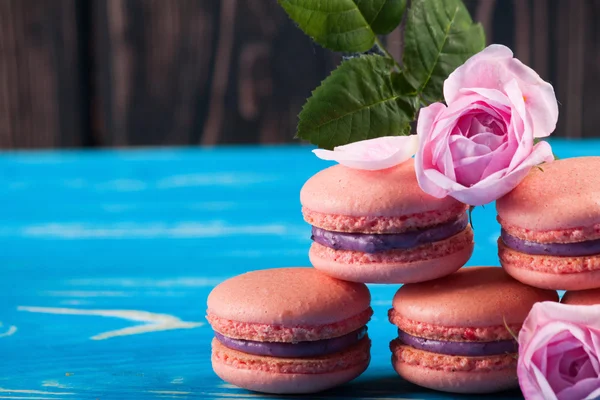 Multicolored macaroon on blue boards. — Stock Photo, Image