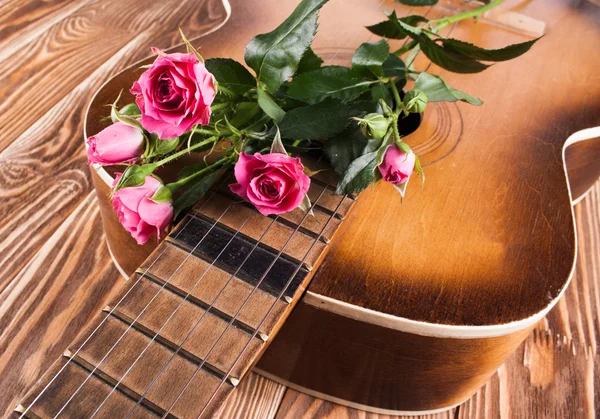 Guitar on wood desk Stock Picture