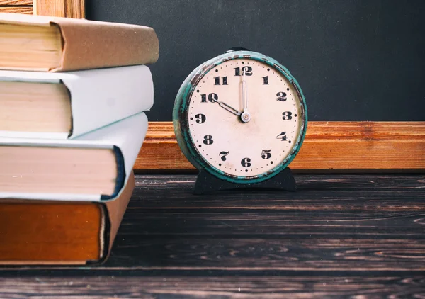 Old books and clock — Stock Photo, Image