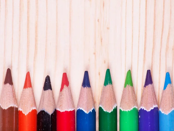 Lápis coloridos sobre fundo de madeira — Fotografia de Stock