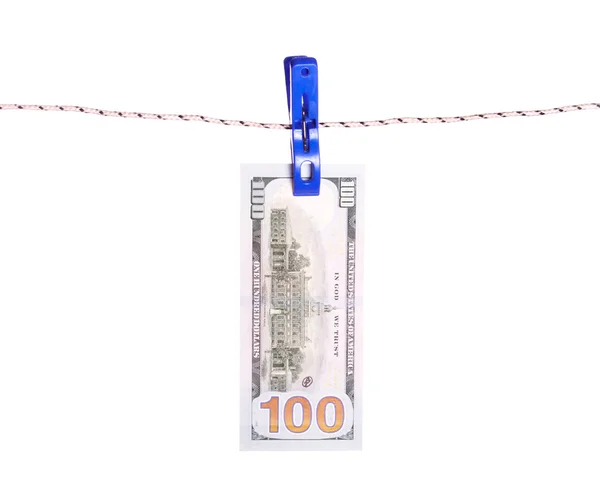 Billetes de dólar colgando de una cuerda con alfileres de ropa . — Foto de Stock