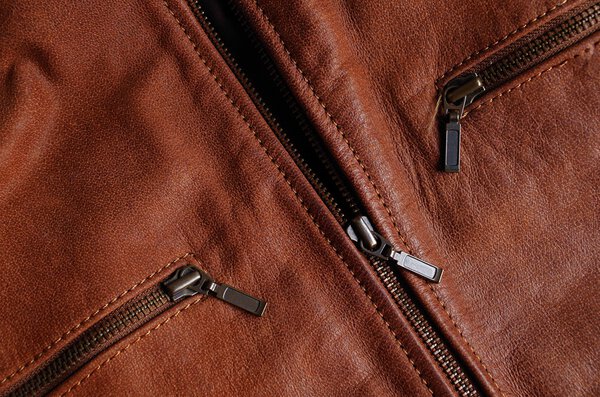 Zippers of a brown leather jacket