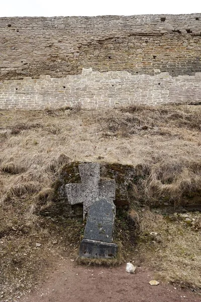 Cross at the base of the Izborsk fortress. Spring