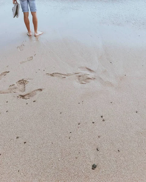 Barefoot man on a beach