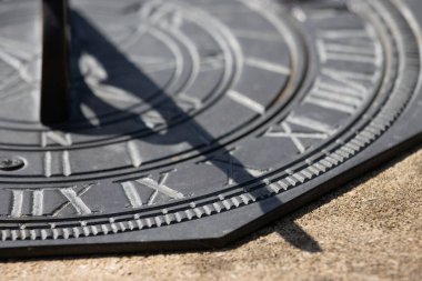Close up of shadow showing time on metal sundial clock