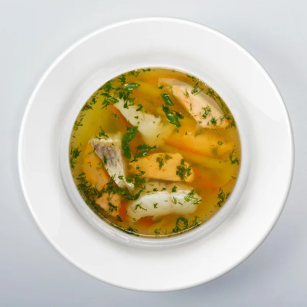 Sopa de peixe Em prato redondo branco — Fotografia de Stock