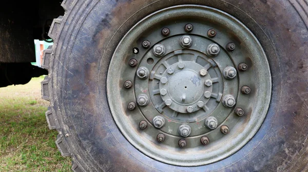 Nut with bolts and tire wheels. Big wheel cargo semi truck with copy space. Close focus and select an object