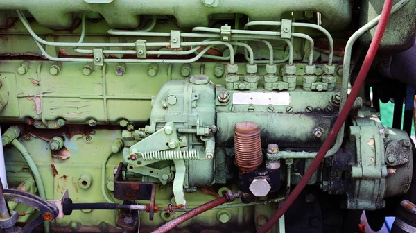 Details of the old green diesel engine. Oil pipelines from injectors of old diesel engines that are outdated and dirty because of poor maintenance. Close focus and select an object