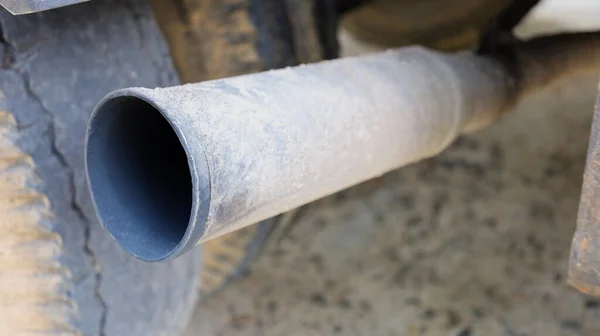Old truck exhaust. Steel pipes are dirty black due to exhaust fumes sticking inside. focus close to the subject