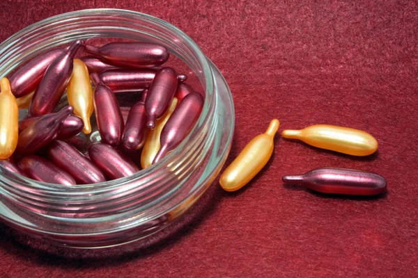 Gold Capsules Face Isolated Red Background Purple Capsules Face — Stock Photo, Image