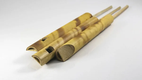 Few small bamboo flutes. popular toy gift of children with sweet sounds. Musical Bird Call Sound Sliding Flute. Flute Imitator Bird Sound. While blowing, pull the small bamboo pole back and forth.