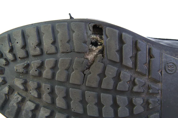 Black shoe with a hole in the sole isolated on white background. — Stock Photo, Image