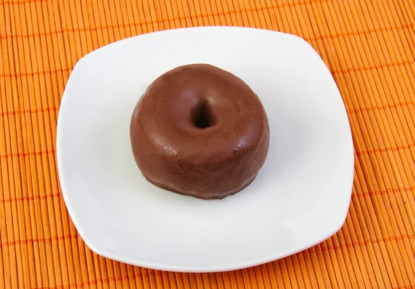 Chocolate doughnut. Donut in a white dish — Stock Photo, Image