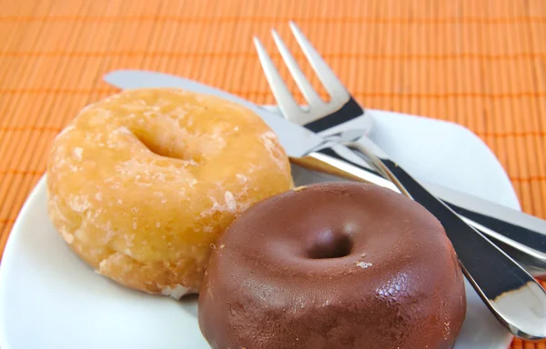 Chocolate and glazed doughnut on wooden background. Donuts. — Stock Photo, Image