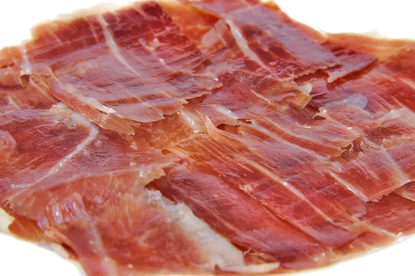 Closeup of spanish serrano ham on white background. — Stock Photo, Image