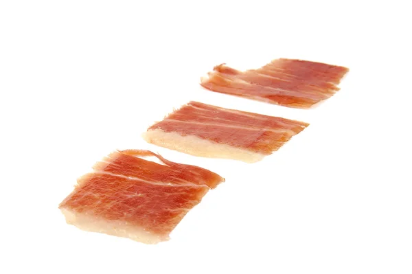 Beyaz arka plan üzerinde izole üç İspanyol serrano jambonu dilimleri. — Stok fotoğraf