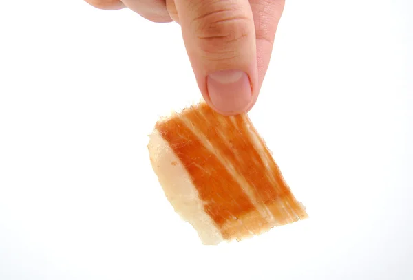 Man holding a serrano ham slice. Jabugo. Spanish tapa. — Stock Photo, Image