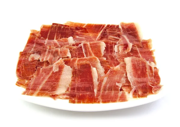 Serrano ham segmenten op een witte schotel. Jabugo. Spaanse tapa. — Stockfoto