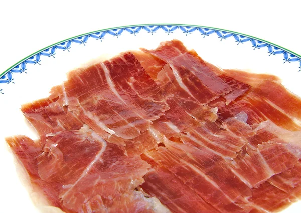 Closeup of serrano ham slices on a dish. Jabugo. Spanish tapa. — Stock Photo, Image