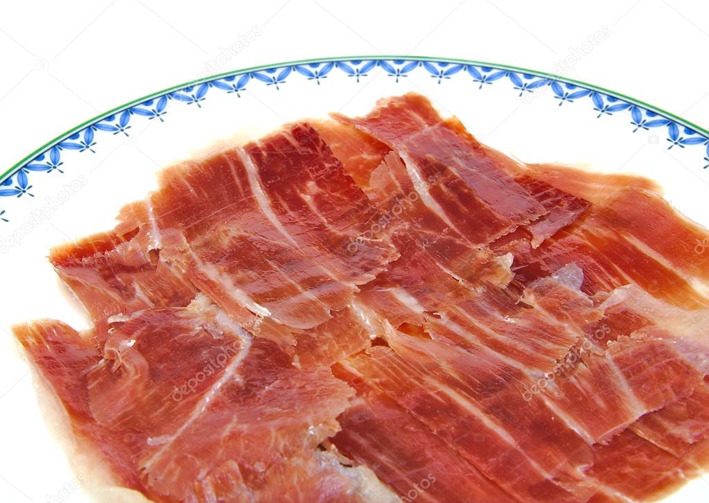 Closeup of serrano ham slices on a dish. Jabugo. Spanish tapa.