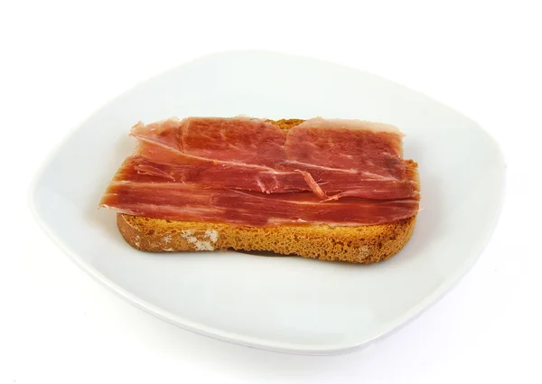 Serrano ham on toasted bread. Jabugo. Spanish tapa. — Stock Photo, Image