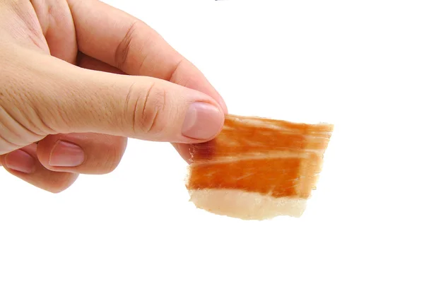 Man holding a hand cut serrano ham slice isolated on white background. Jabugo. Spanish tapa. — Stock Photo, Image