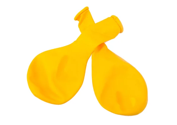 Dos globos amarillos desinflados sobre fondo blanco — Foto de Stock