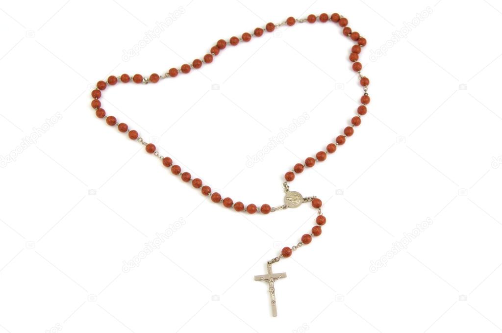Wood rosary and metal cross with slightly unfocused beads isolated on a white background