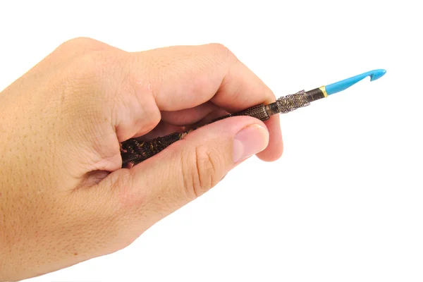 Hand holding very old crochet hook isolated on a white background — Stock Photo, Image