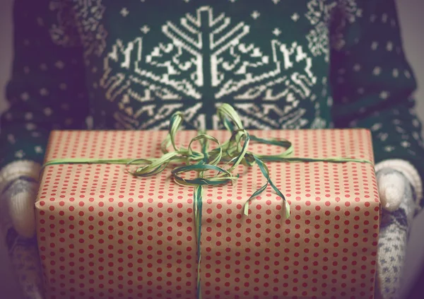 Girl holds in hands Christmas present — Stock Photo, Image