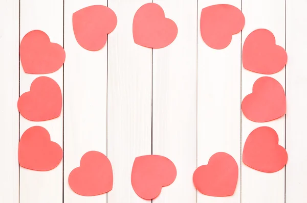 Red heart stickers on a light wooden background — Stock Photo, Image