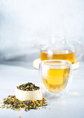 Japanese green tea Genmaicha.Tea leaves with fried brown rice on a bright gray background with a shadow.Slimming trend tea concept. a cup of tea. brew a transparent teapot clipart
