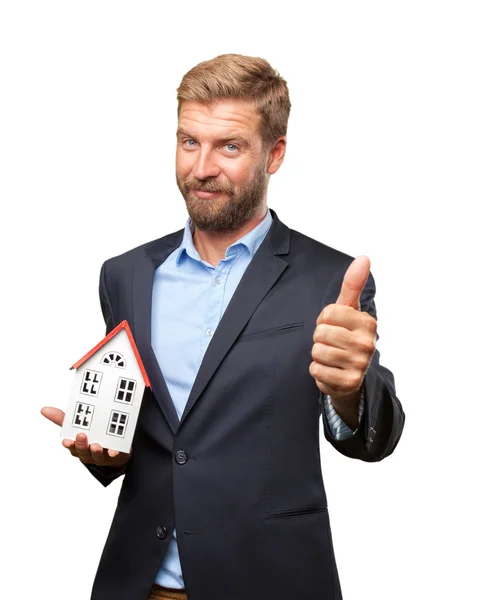 Blond businessman with toy house — Stock Photo, Image