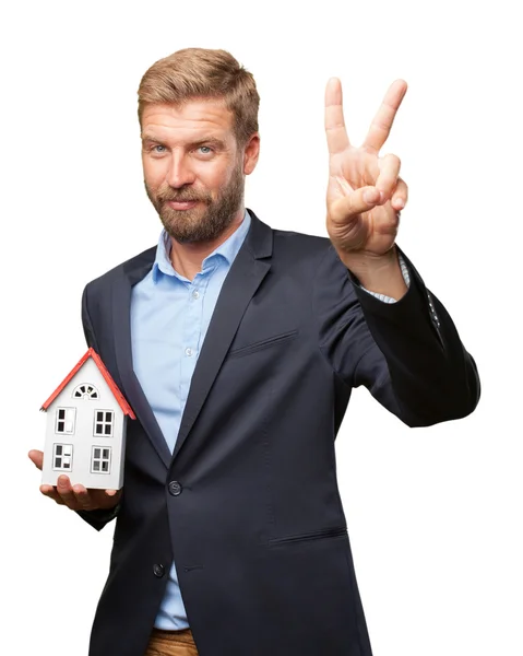 Blond businessman with toy house — Stock Photo, Image