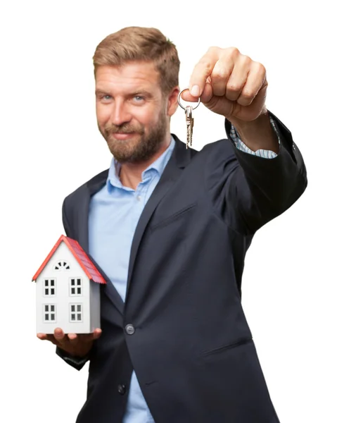 Blond businessman with toy house and key — Stock Photo, Image