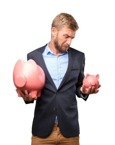 Blond businessman with pink piggybanks — Stock Photo, Image