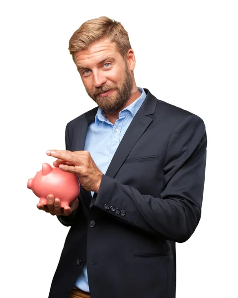 Blond affärsman med rosa piggybank — Stockfoto