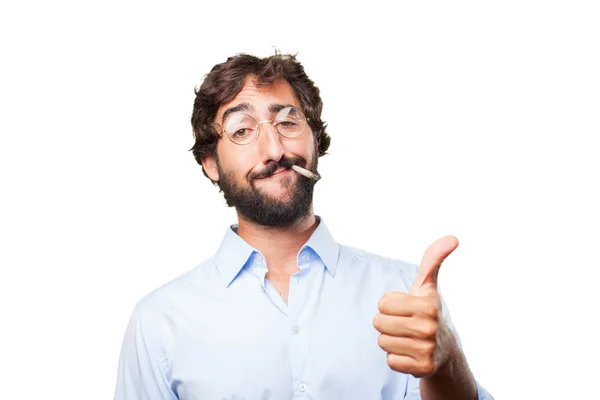 Crazy man smokes cigarette with expression — Stock Photo, Image