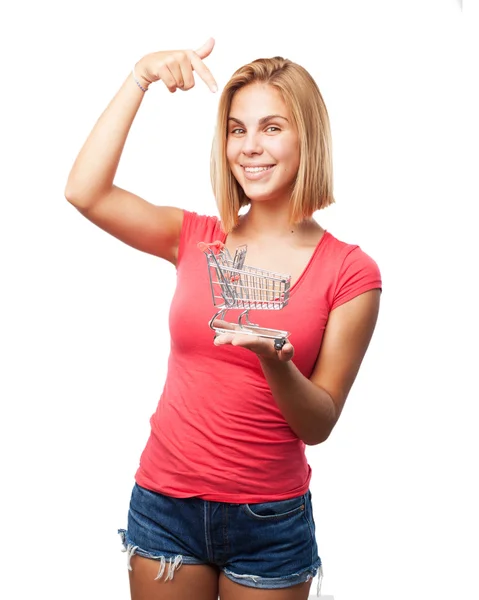 Young blond girl with shopping cart — Stock Photo, Image