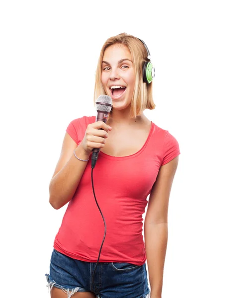 Young blonde girl singing into microphone — Stock Photo, Image