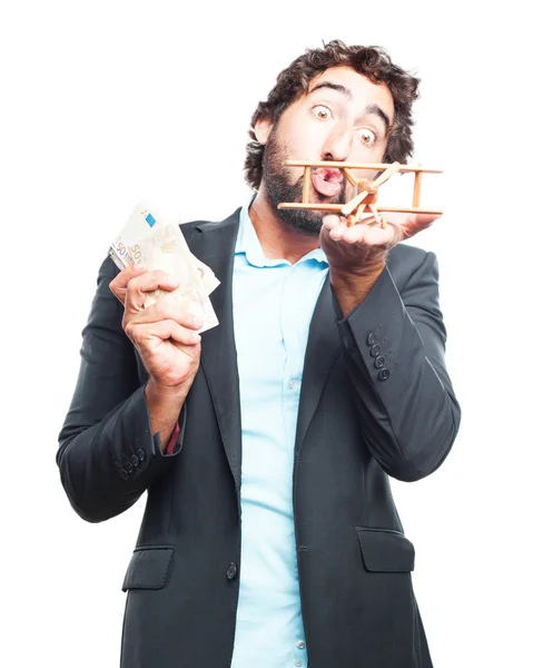 Бизнесмен с банкнотами и игрушечным самолетом — стоковое фото