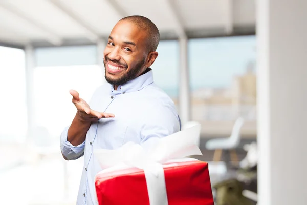 Black businessman with gift box — Stock Photo, Image