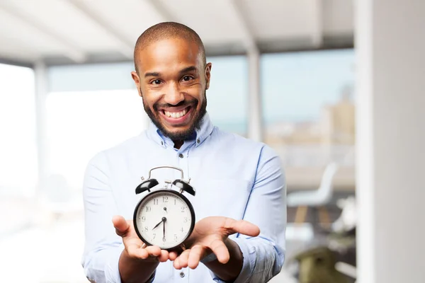 Black businessman with alarm clock — Stock Photo, Image